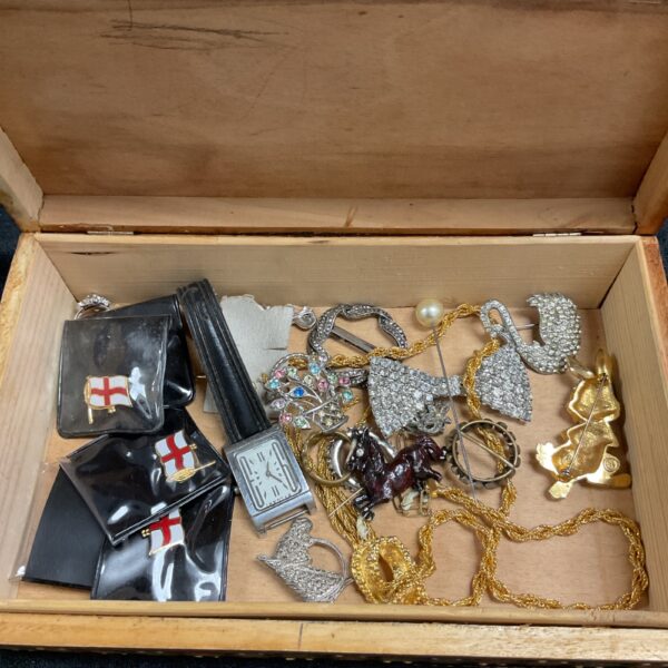 Open vintage jewellery box filled with costume jewellery and accessories.