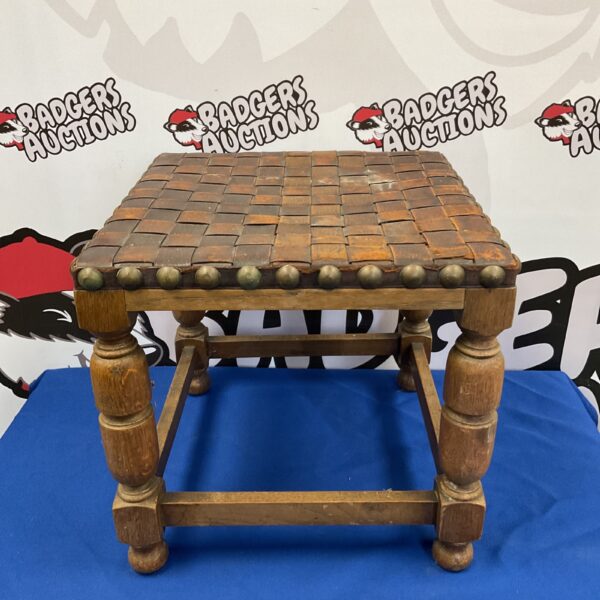 Vintage leather footstool with intricate lattice work design.
