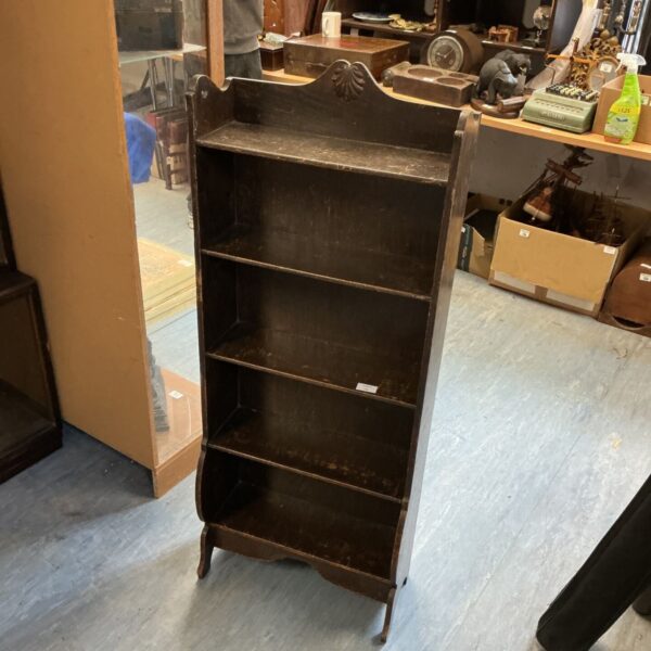 Vintage mahogany bookcase with open shelving for books and collectibles.