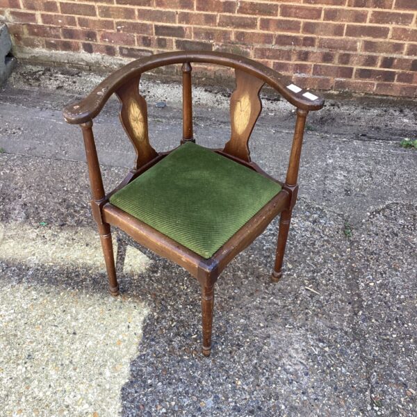 Vintage mahogany corner chair with green upholstered seat.