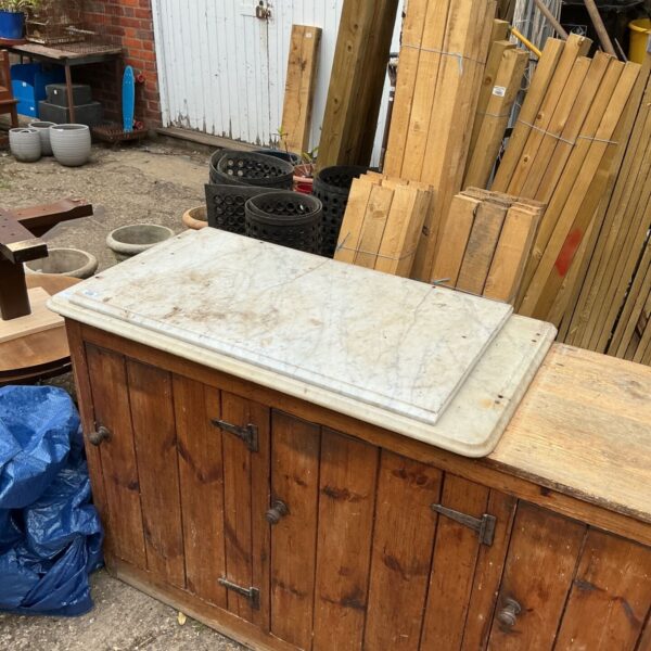 Vintage marble top kitchen base with wooden cabinet.
