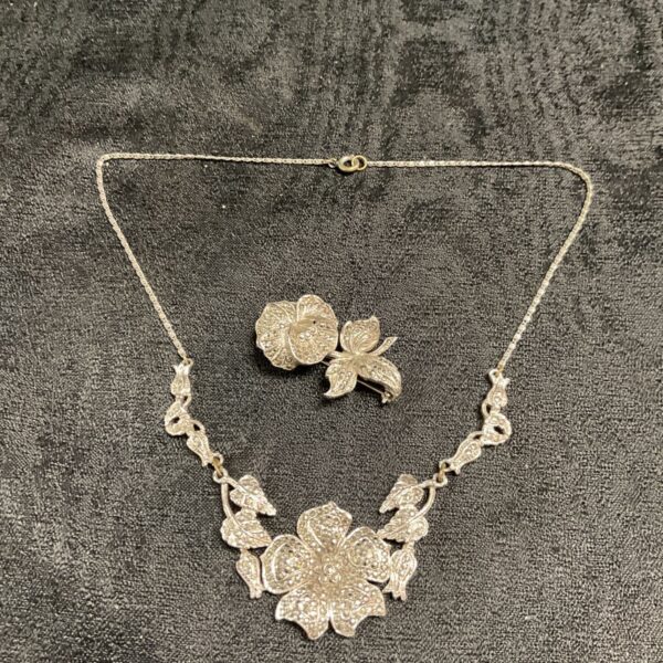 Vintage marcasite necklace and brooch with floral design.