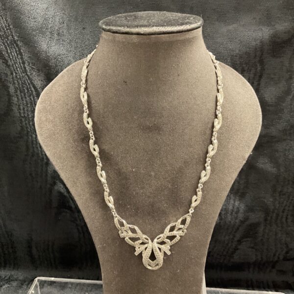 Close-up of vintage marcasite necklace with floral design.