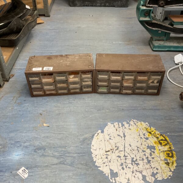 Vintage metal parts cabinet with drawers for workshop storage.