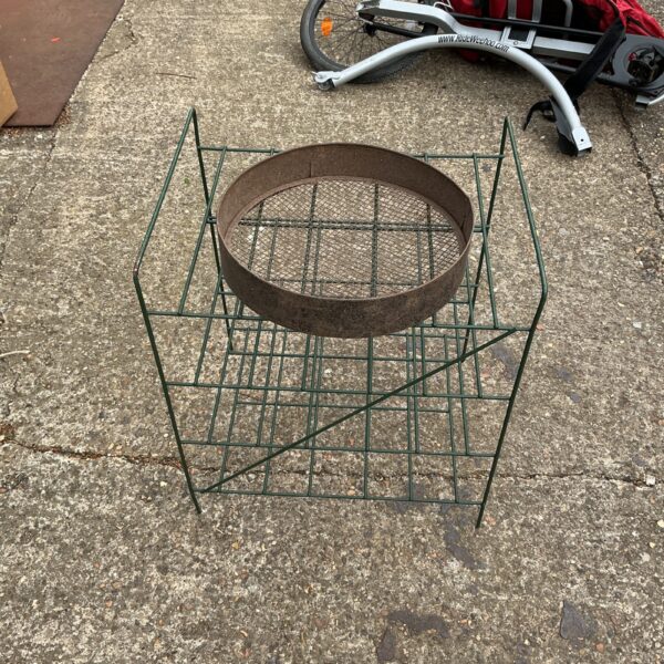 Vintage metal plane stand for displaying aviation models.