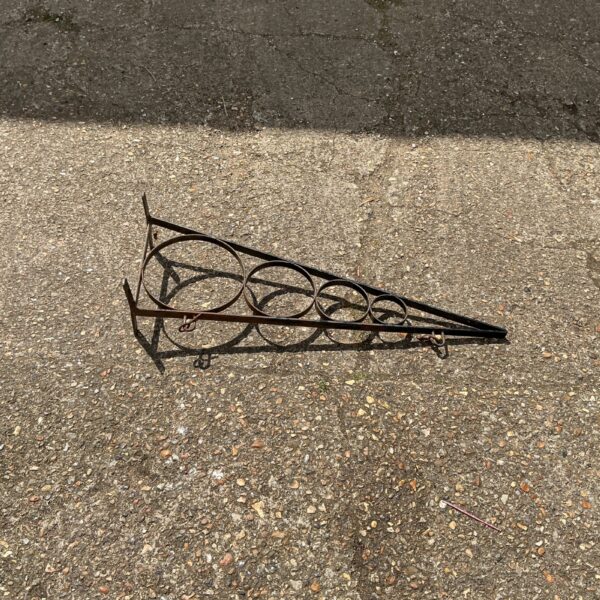 Vintage metal sign bracket for shop or home display.
