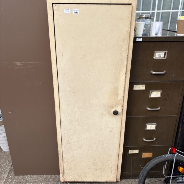 Front view of a vintage metal storage cabinet with a beige finish.