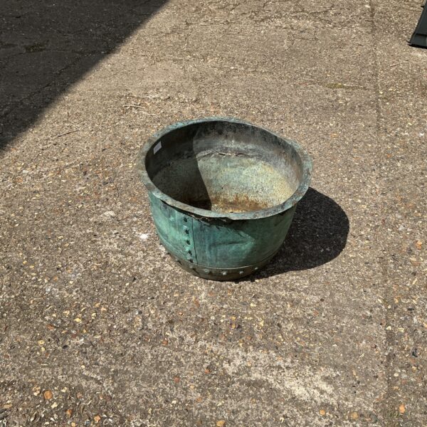 Weathered vintage metal tub, ideal for garden or rustic decor.