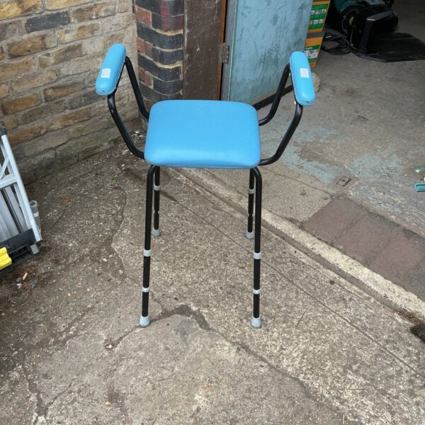 Vintage mobility high chair with adjustable legs and armrests.
