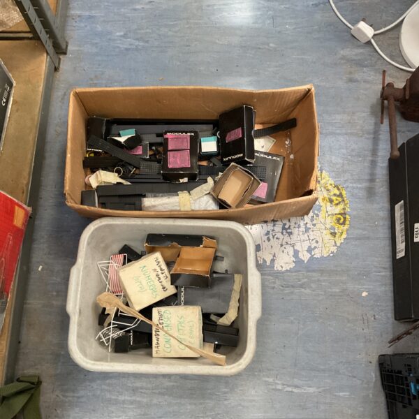 Vintage Modulex components in a cardboard box, offering modular storage solutions.