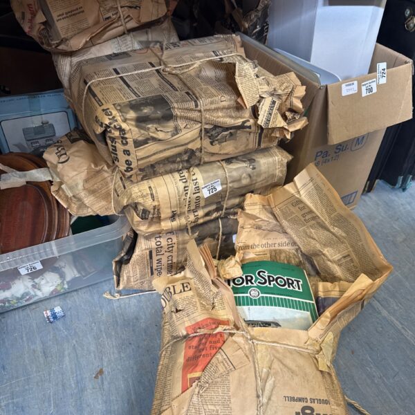 Stack of vintage motorsport magazines, a collectible lot for enthusiasts.