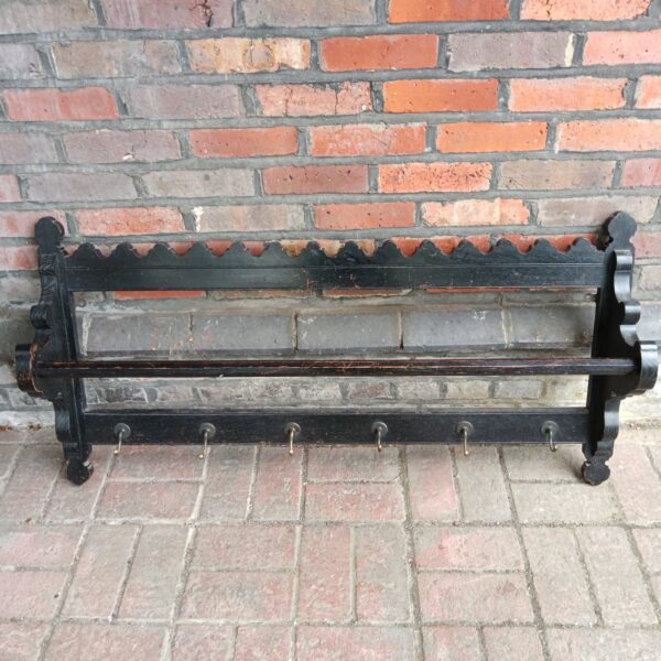 Vintage oak wall mounted coat rack with five hooks.