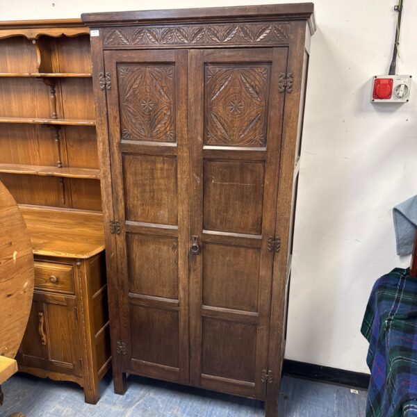 Vintage oak wardrobe with carved details, Arts and Crafts style.