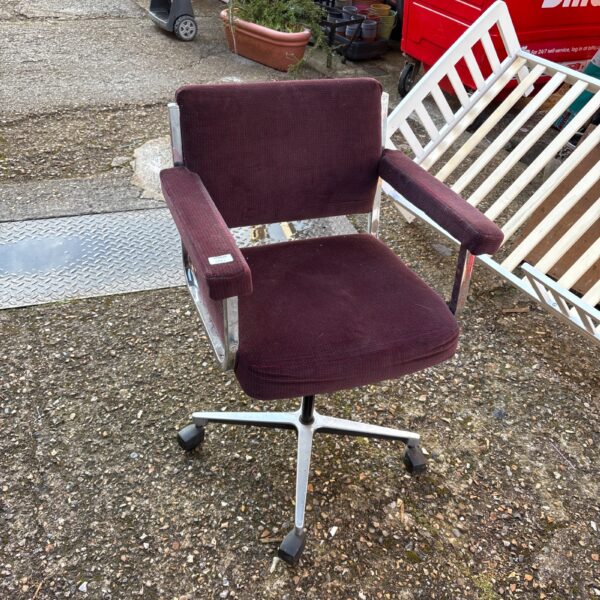 Vintage chrome and fabric office swivel chair in a home setting.