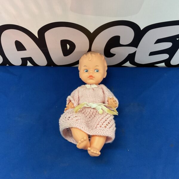 Vintage PaliToy baby doll in pink knitted outfit.