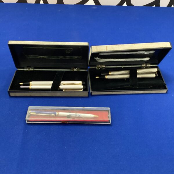 Vintage pen collection featuring Courvoisier and Rothmans pens.