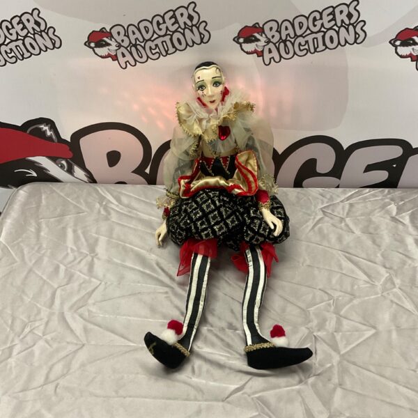 Vintage Pierrot doll with porcelain face and ruffled costume.
