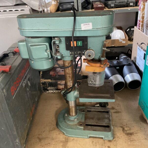 Vintage Bosch pillar drill for metalworking, showing wear and patina.