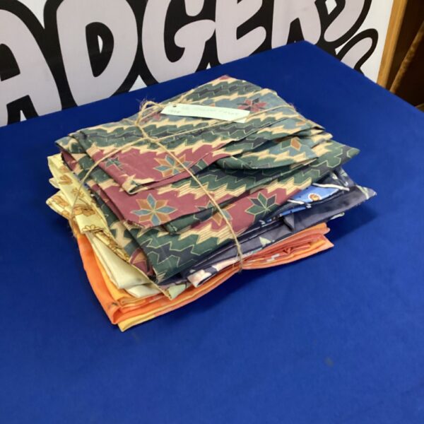 Assorted vintage pillowcases with floral and patterned designs.