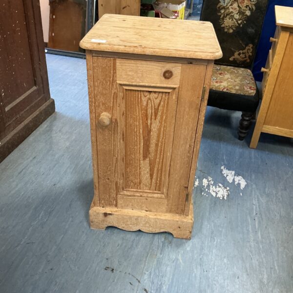 Vintage pine cabinet with a single door, rustic farmhouse style.