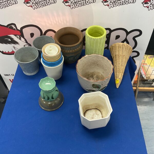 Vintage pottery collection with ceramic vases and decorative pots.