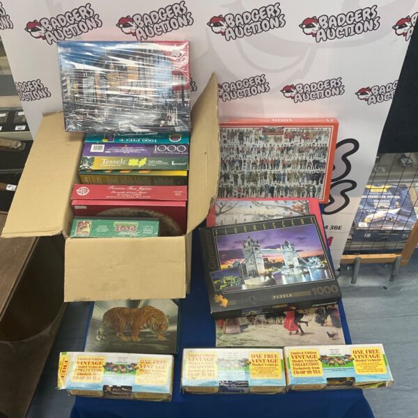 Vintage puzzle and diecast car collection in a box.