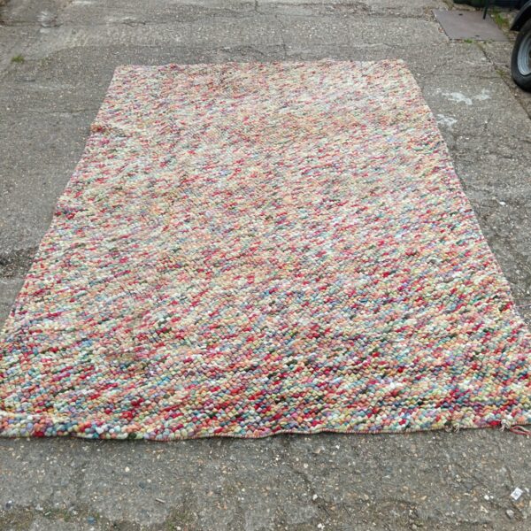 Large colourful vintage rag rug with patchwork design.