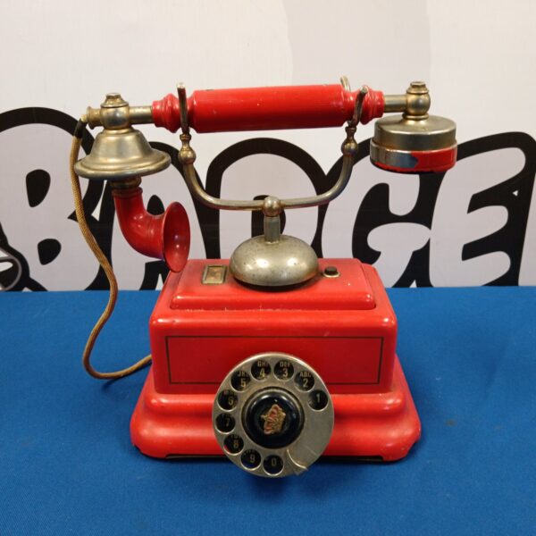 Vintage red Ericsson rotary telephone with handset.