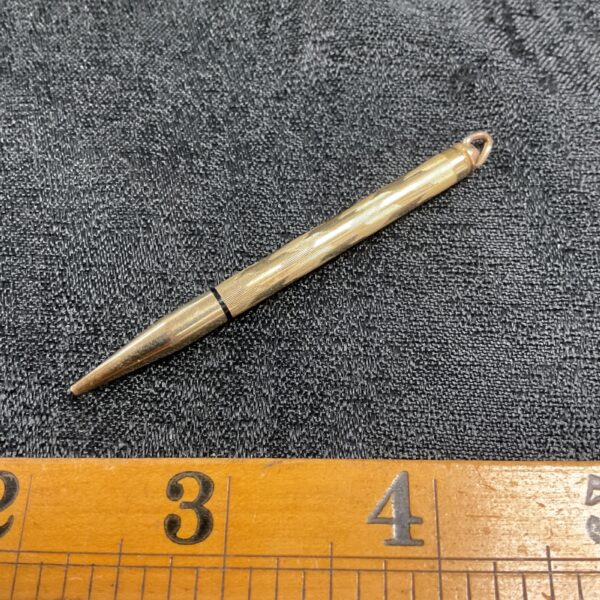 Close-up of vintage 1/30th 10K rolled gold mechanical pencil.