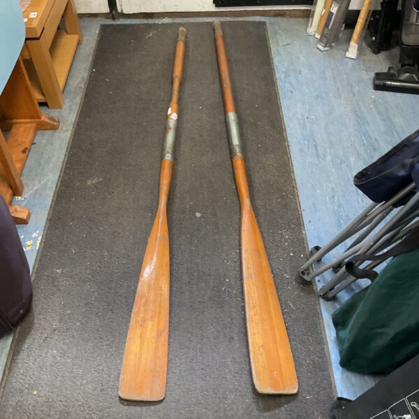 Vintage pair of wooden rowing oars, likely Norvall manufactured.