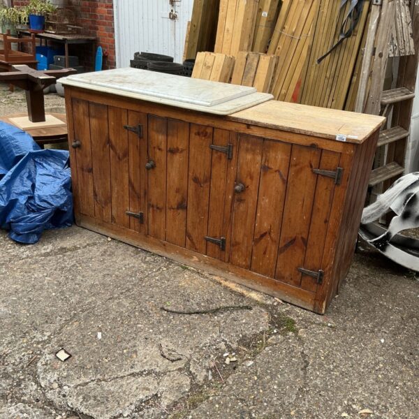 Vintage rustic wooden dresser with drawers, ideal for storage.
