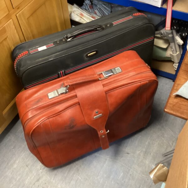 Vintage brown leather Samsonite suitcase with wheels.