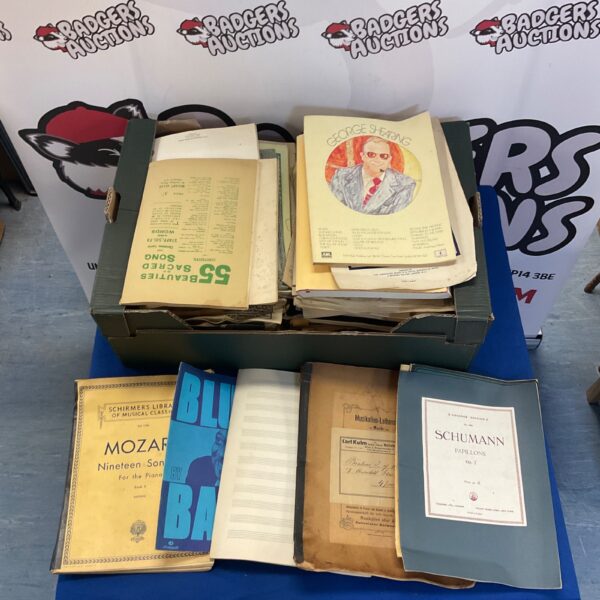 Large collection of vintage sheet music books and songbooks.