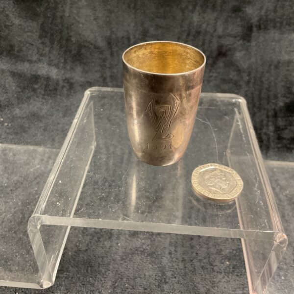 Vintage silver Snapz cup with embossed design, dated 1921.