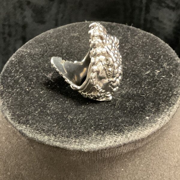 Close-up of vintage silver tone snake ring, size J.