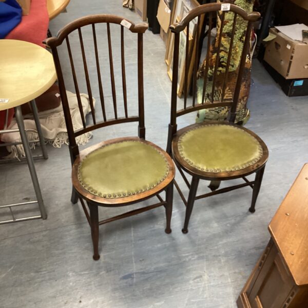 Pair of vintage stick back chairs with green upholstery.