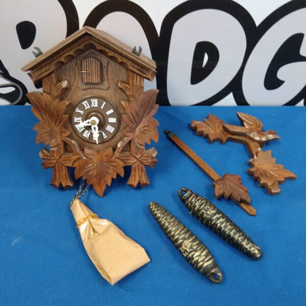 Vintage Swiss cuckoo clock with weights and pendulum.
