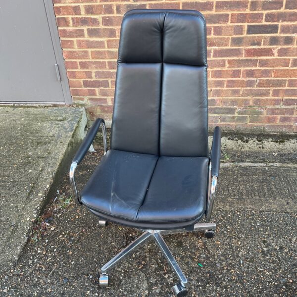 Vintage swivel office chair with chrome base and worn leather upholstery.