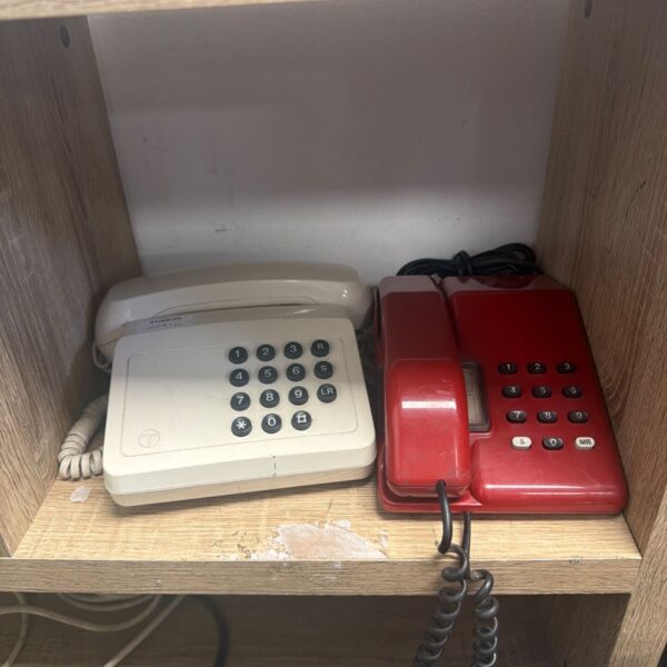 Cream vintage rotary dial wall telephone, retro style.