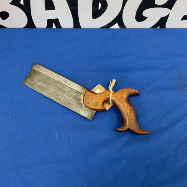 Vintage tension saw with wooden handle and steel blade.