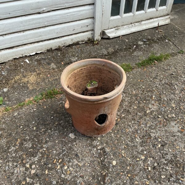Vintage terracotta strawberry planter for growing plants outdoors.