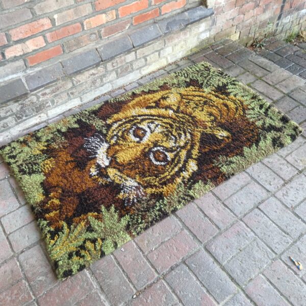 Vintage hand made tiger rug with detailed animal design.
