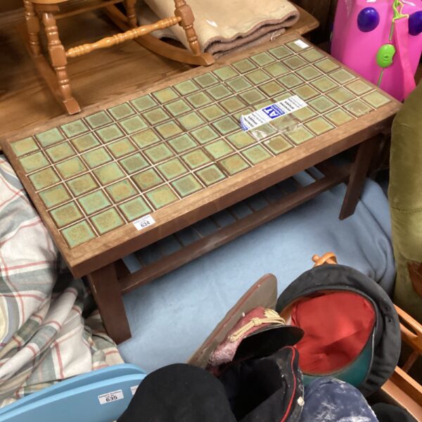 Vintage tile top table awaiting restoration, featuring green mosaic tiles.