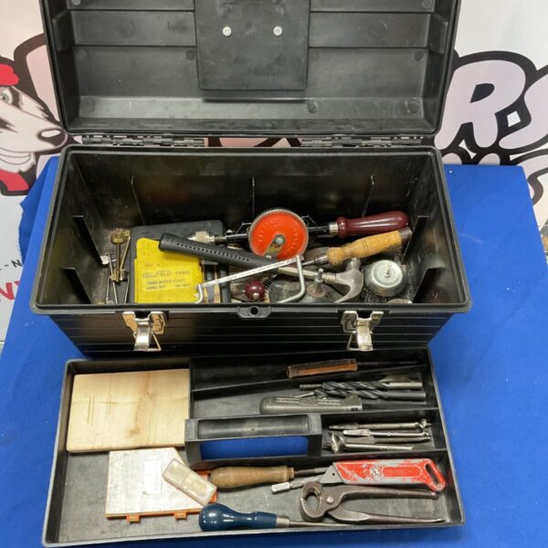 Vintage black tool box filled with assorted hand tools.