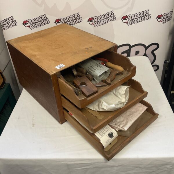 Vintage wooden tool cabinet filled with antique tools.
