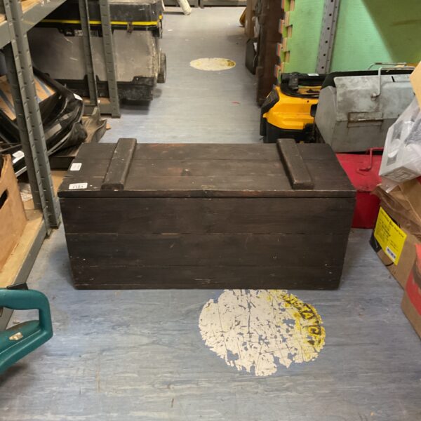 Full view of a vintage wooden tool crate with spanners inside.