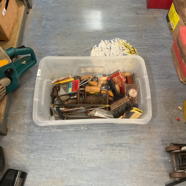 Vintage tool lot with hacksaws, drills, and other hand tools.