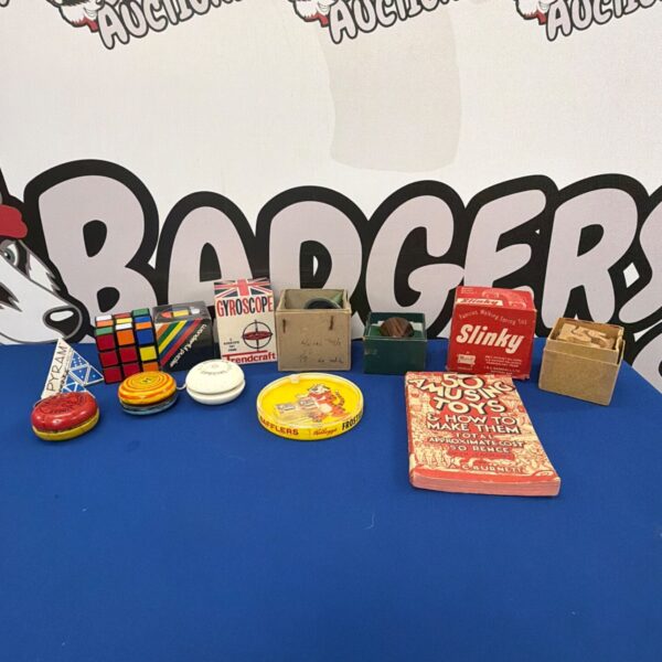 Vintage toy lot featuring a Slinky and gyroscope.