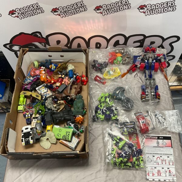 Vintage toy lot featuring Transformers and collectible action figures.