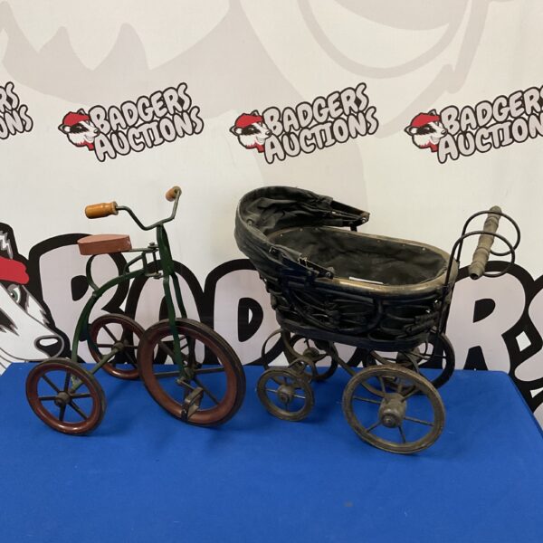 Vintage tricycle and Victorian pram planter, antique metal garden decor.